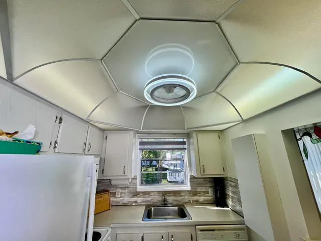 a kitchen with a refrigerator and a sink