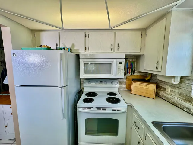 a kitchen with a stove a refrigerator and a sink