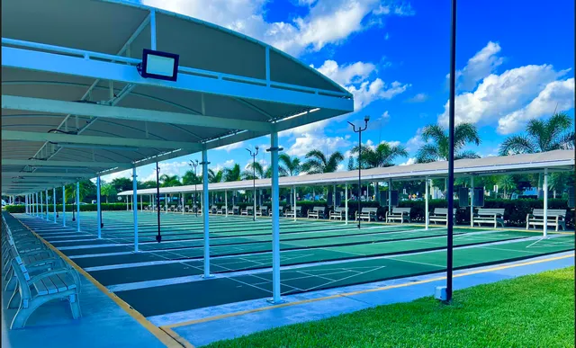 a view of a swimming pool with a yard and sitting area