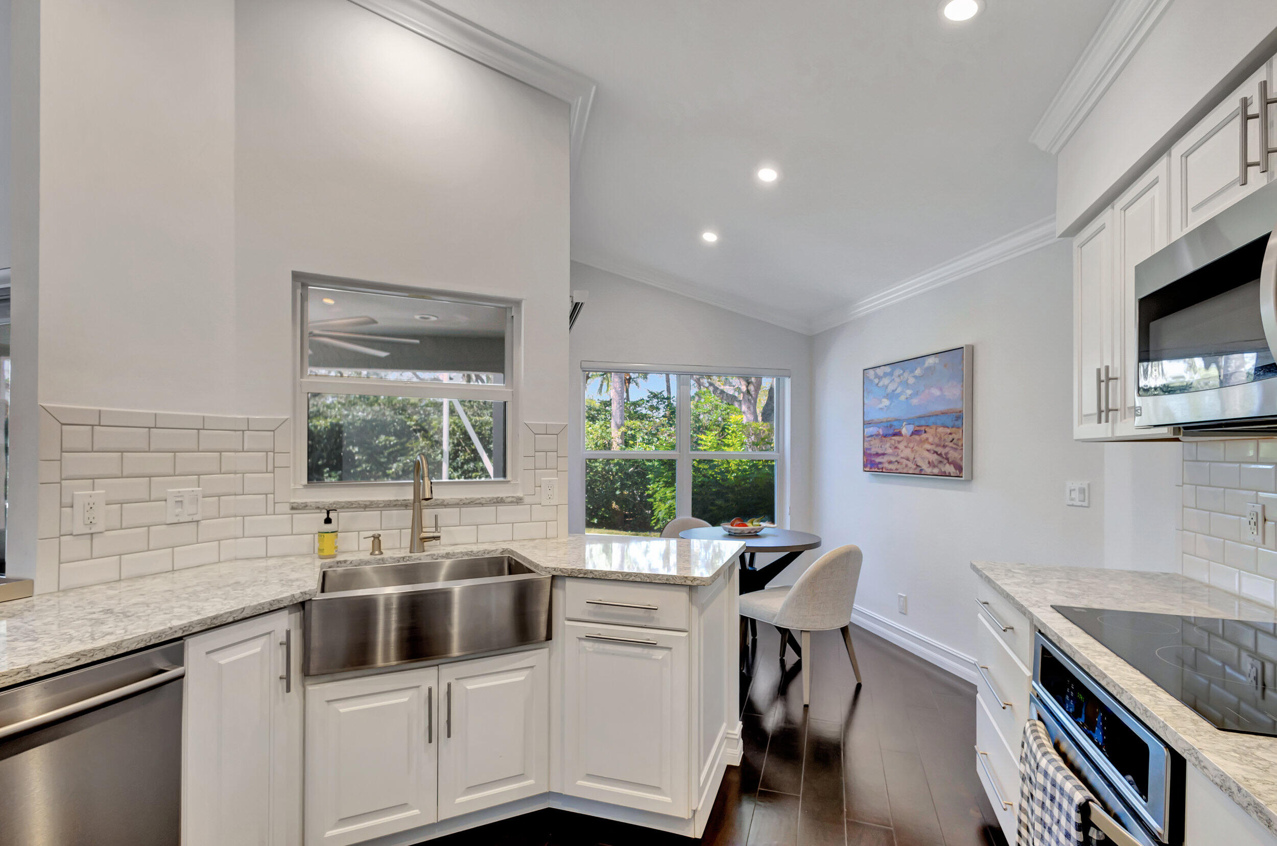 16501 Riverwind Drive Jupiter, FL 33477 - Photo 17 of 50 a kitchen with a sink cabinets and window