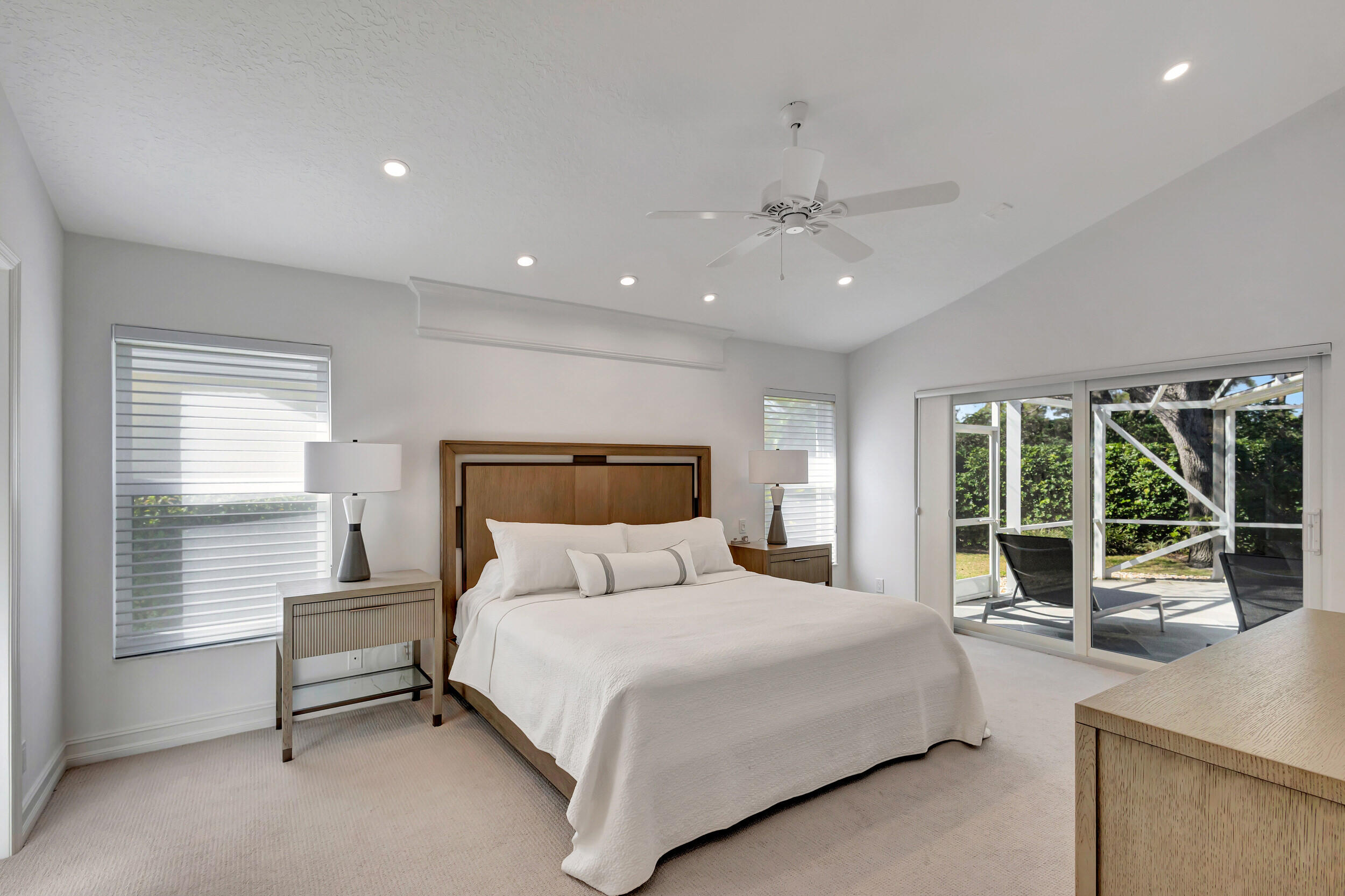 16501 Riverwind Drive Jupiter, FL 33477 - Photo 24 of 50 a bedroom with a large bed and a large window