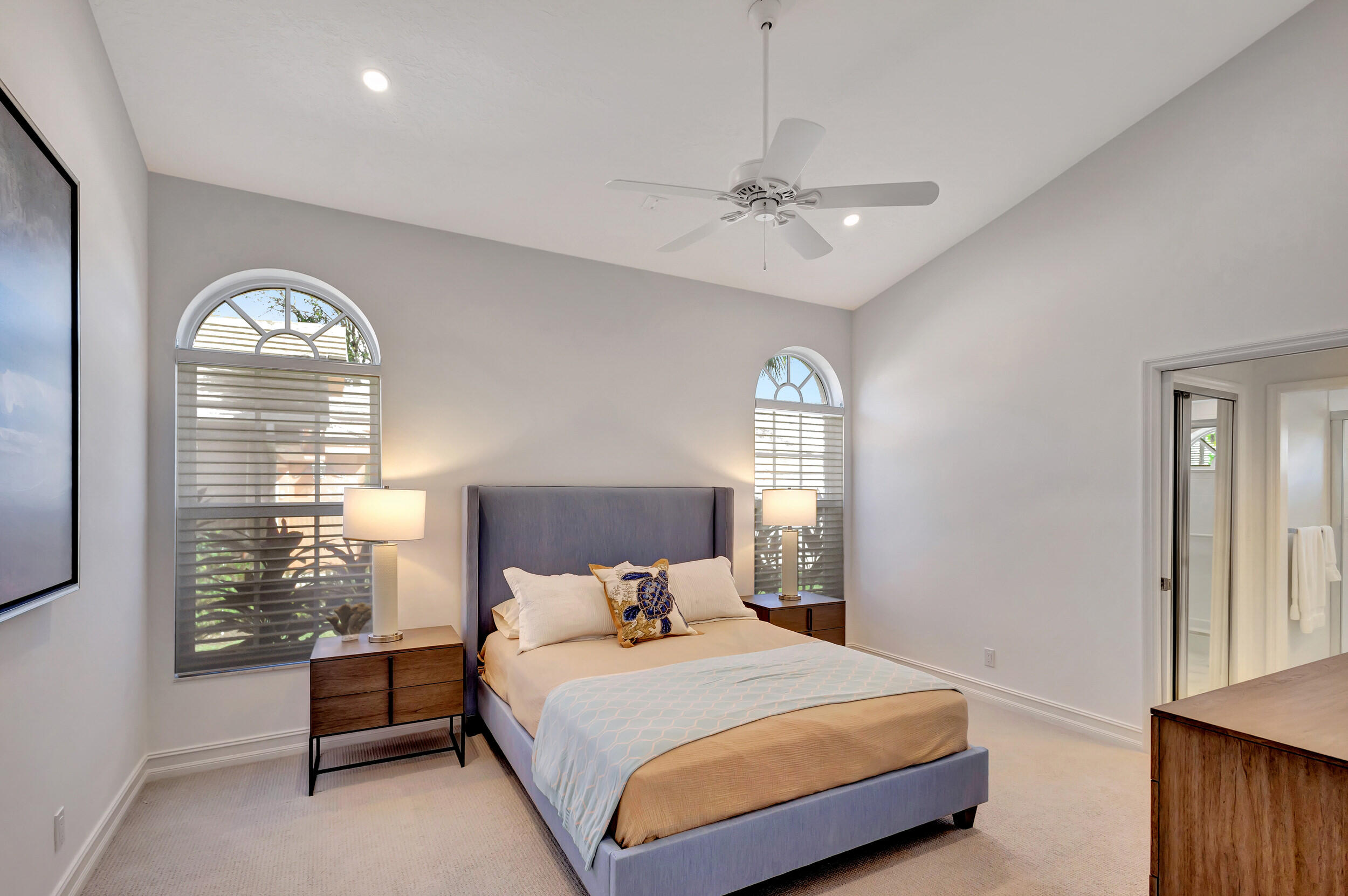 16501 Riverwind Drive Jupiter, FL 33477 - Photo 32 of 50 a bedroom with a bed and a window