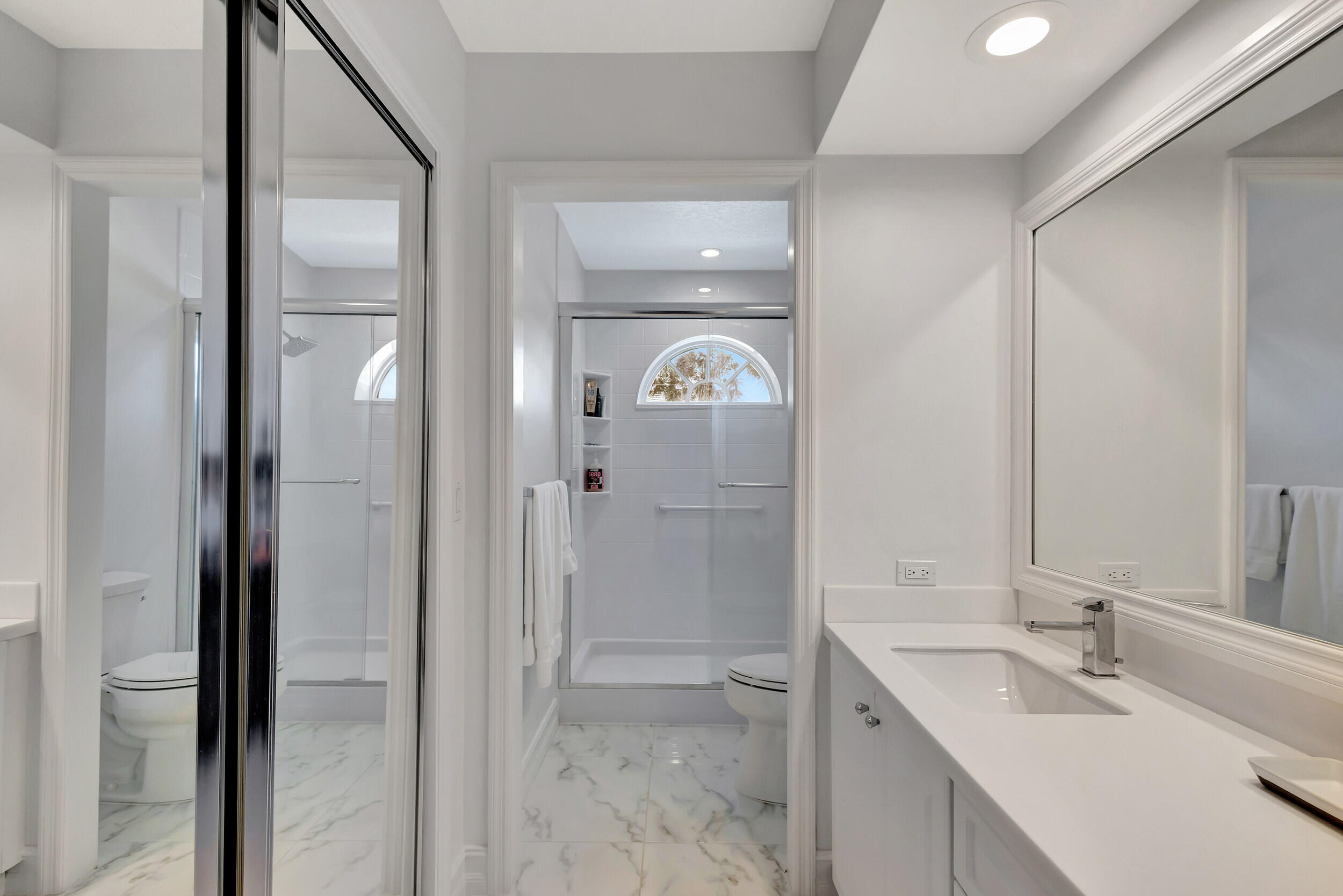 16501 Riverwind Drive Jupiter, FL 33477 - Photo 34 of 50 a bathroom with a sink and a mirror