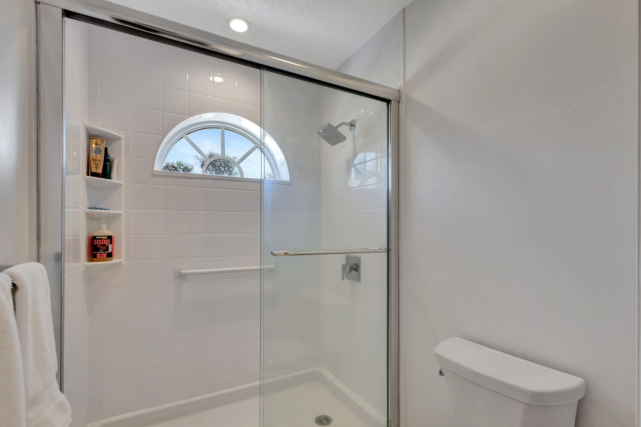 16501 Riverwind Drive Jupiter, FL 33477 - Photo 35 of 50 a bathroom with a toilet sink and shower