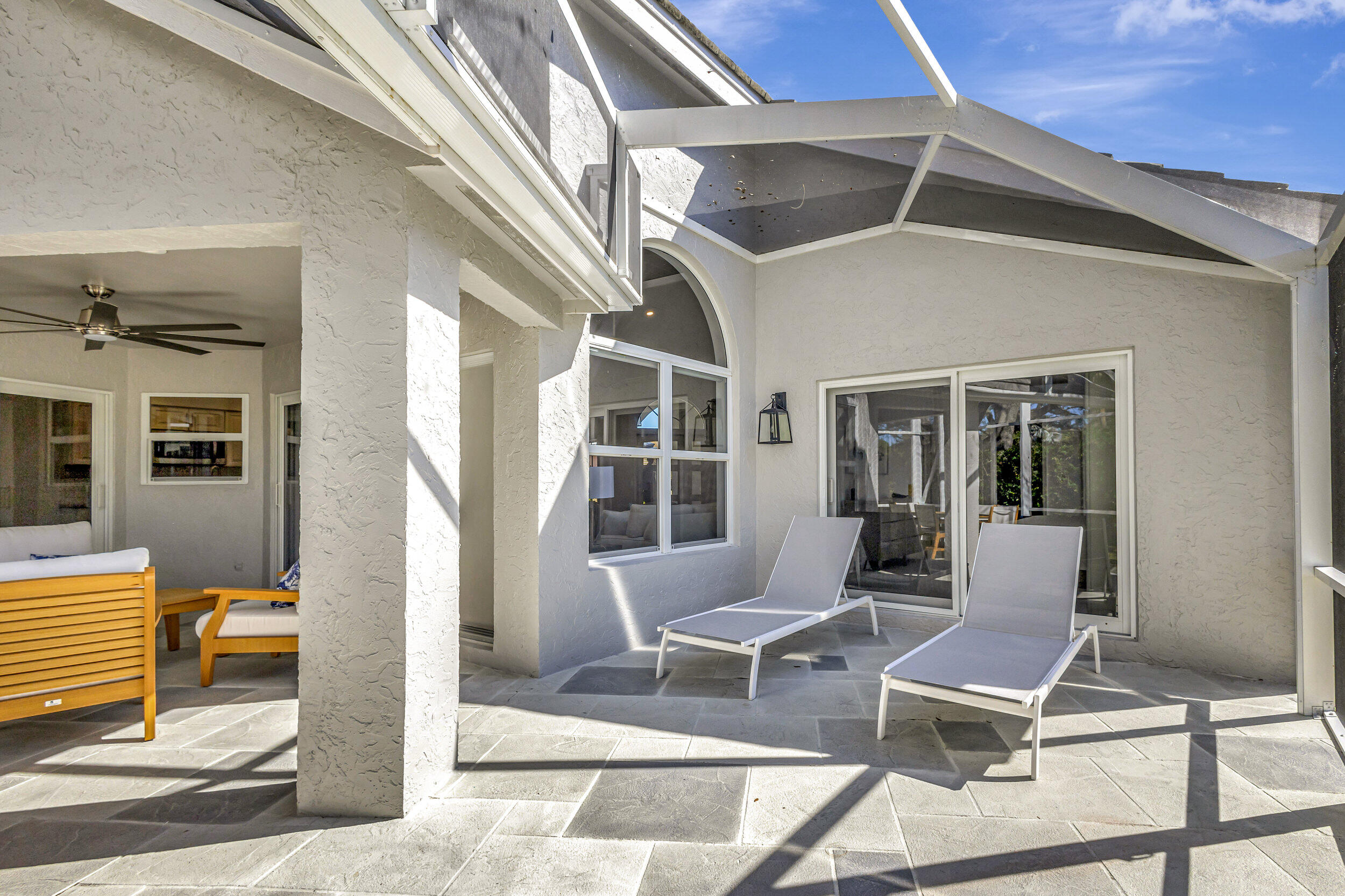 16501 Riverwind Drive Jupiter, FL 33477 - Photo 39 of 50 a building outdoor space with patio furniture and windows