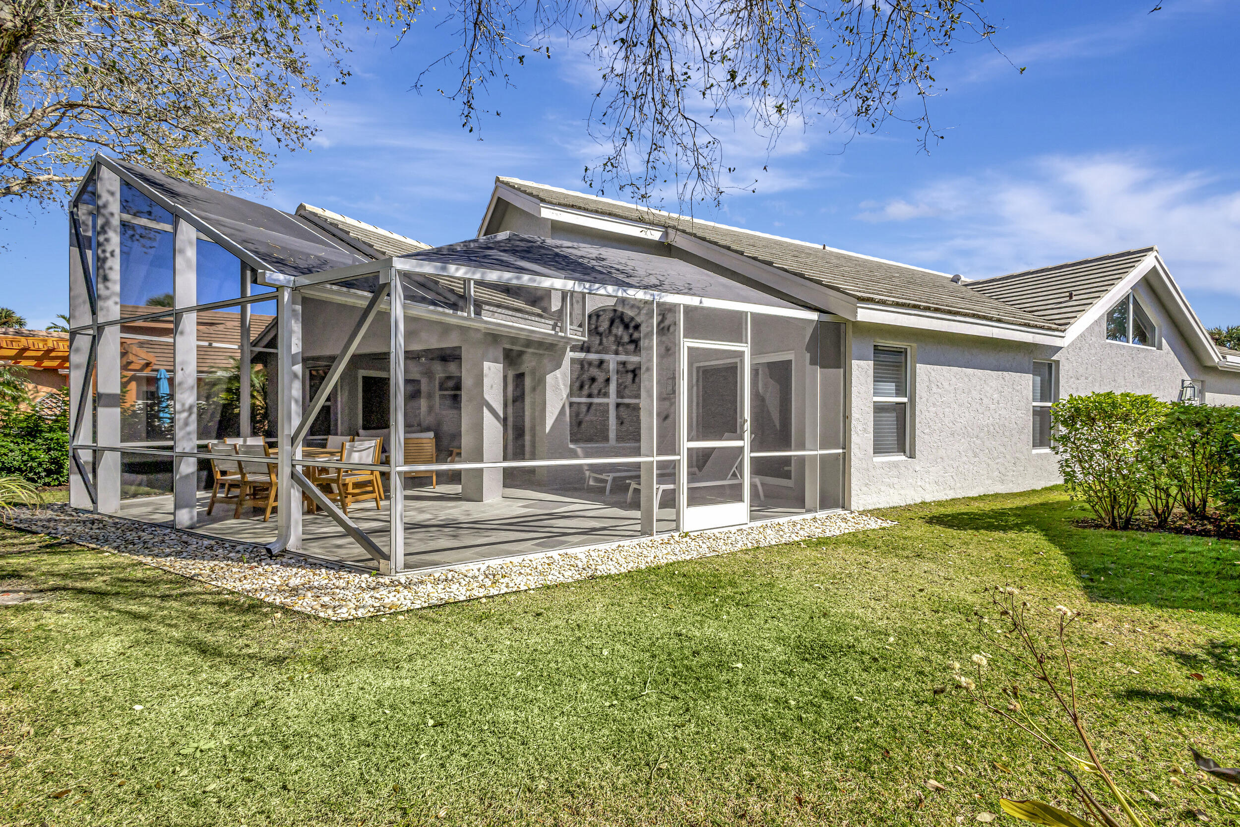 16501 Riverwind Drive Jupiter, FL 33477 - Photo 42 of 50 a view of a house with backyard and porch
