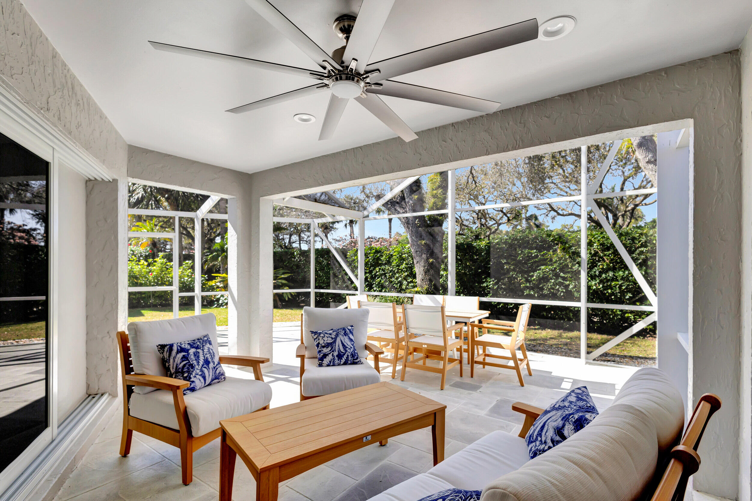 16501 Riverwind Drive Jupiter, FL 33477 - Photo 46 of 50 a living room with furniture a large window and a chandelier