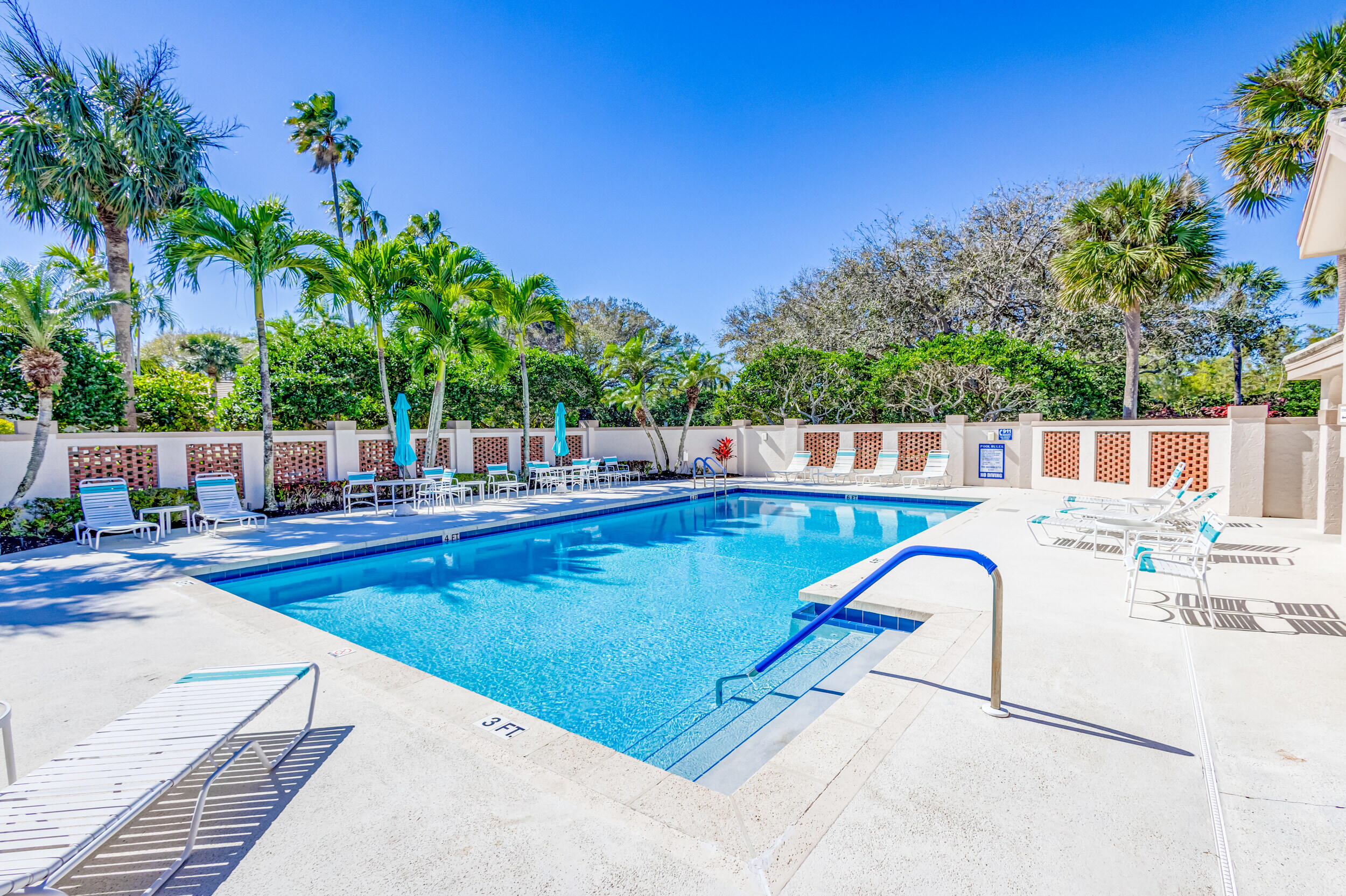 16501 Riverwind Drive Jupiter, FL 33477 - Photo 47 of 50 a view of a swimming pool with a patio
