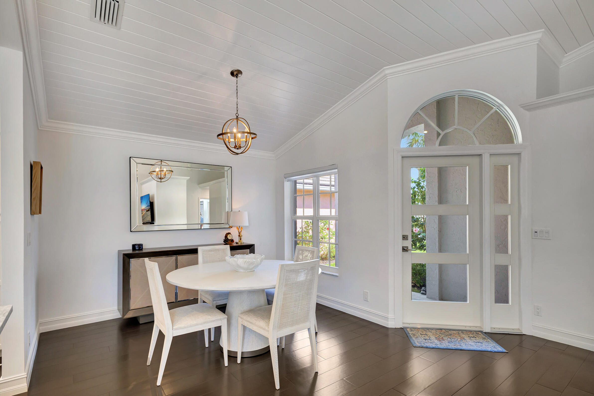 16501 Riverwind Drive Jupiter, FL 33477 - Photo 9 of 50 a view of a dining room with furniture window and wooden floor
