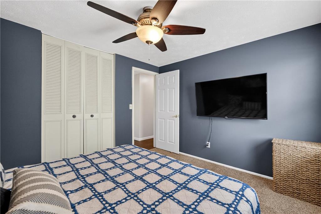 1304 Greenhill Rd Extension Pittsburgh, PA 15209 - Photo 14 of 31 a bedroom with a bed and a flat screen tv
