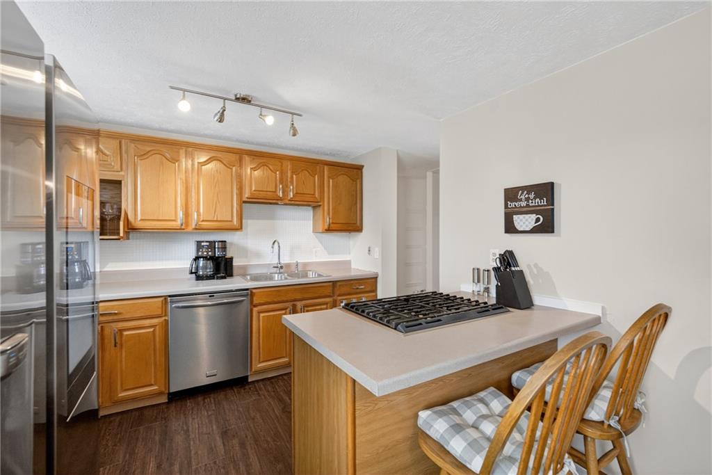 1304 Greenhill Rd Extension Pittsburgh, PA 15209 - Photo 8 of 31 a kitchen with a sink a stove cabinets and wooden floor