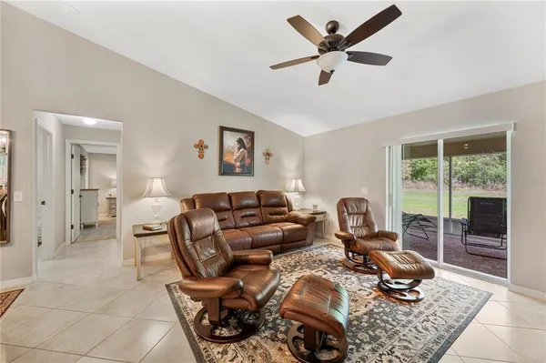 a living room with furniture a flat screen tv and a window
