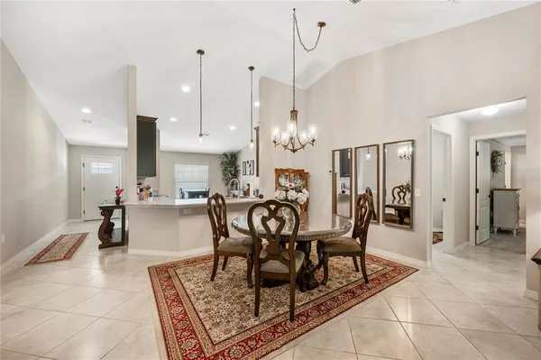 a view of a dining room with furniture and chandelier