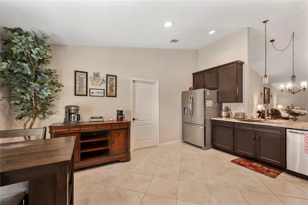 a kitchen with stainless steel appliances granite countertop a refrigerator sink and cabinets