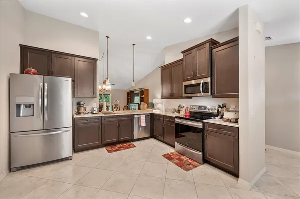 a kitchen with a sink and stainless steel appliances