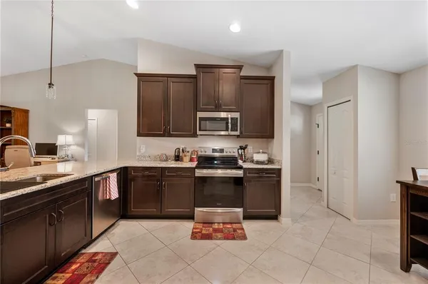 a kitchen with furniture and a refrigerator
