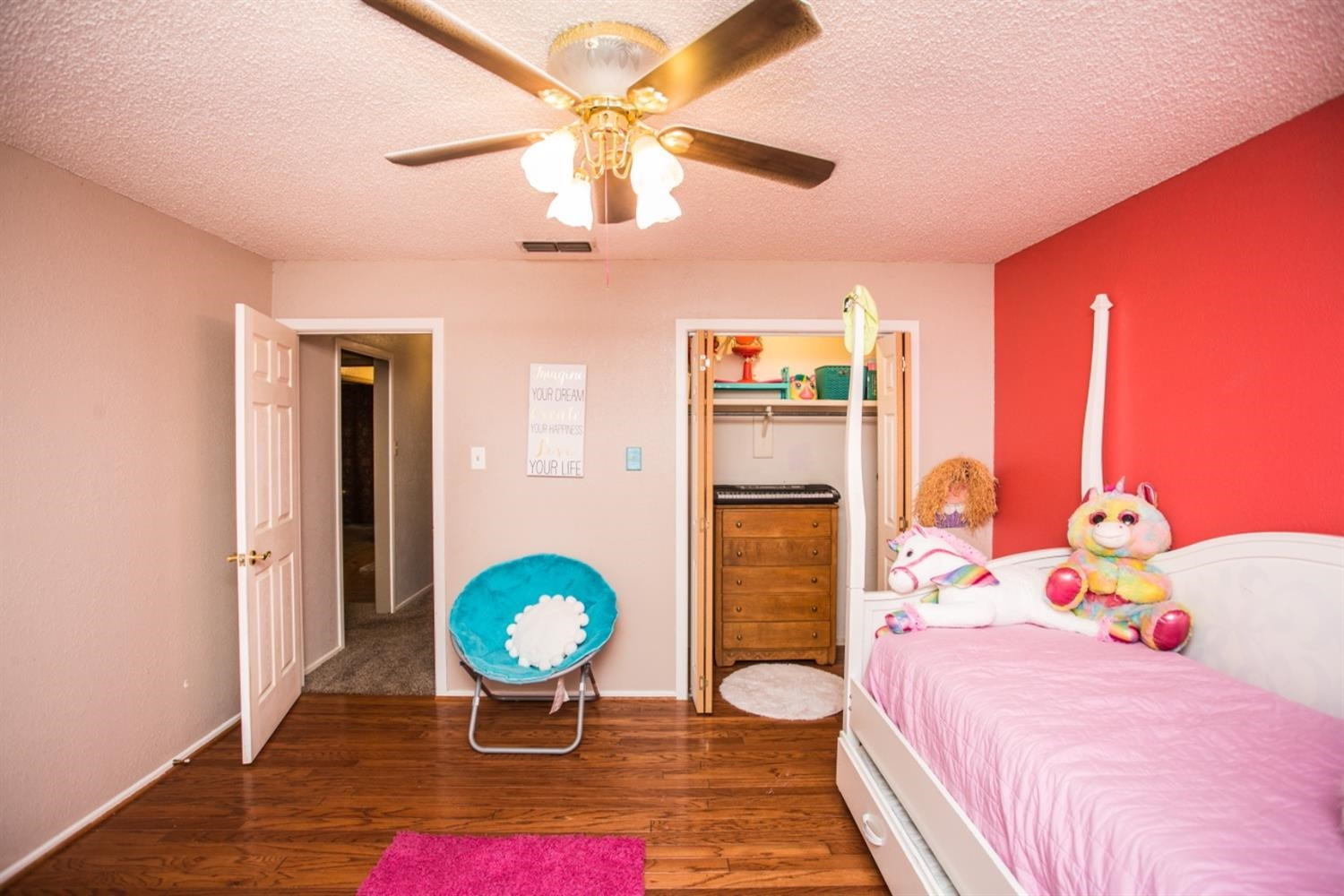 2118 Tech Drive Levelland, TX 79336 - Photo 16 of 42 a bedroom with a bed and a chandelier