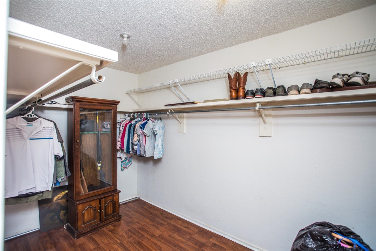 2118 Tech Drive Levelland, TX 79336 - Photo 20 of 42 a view of walk in closet with clothes and shoes
