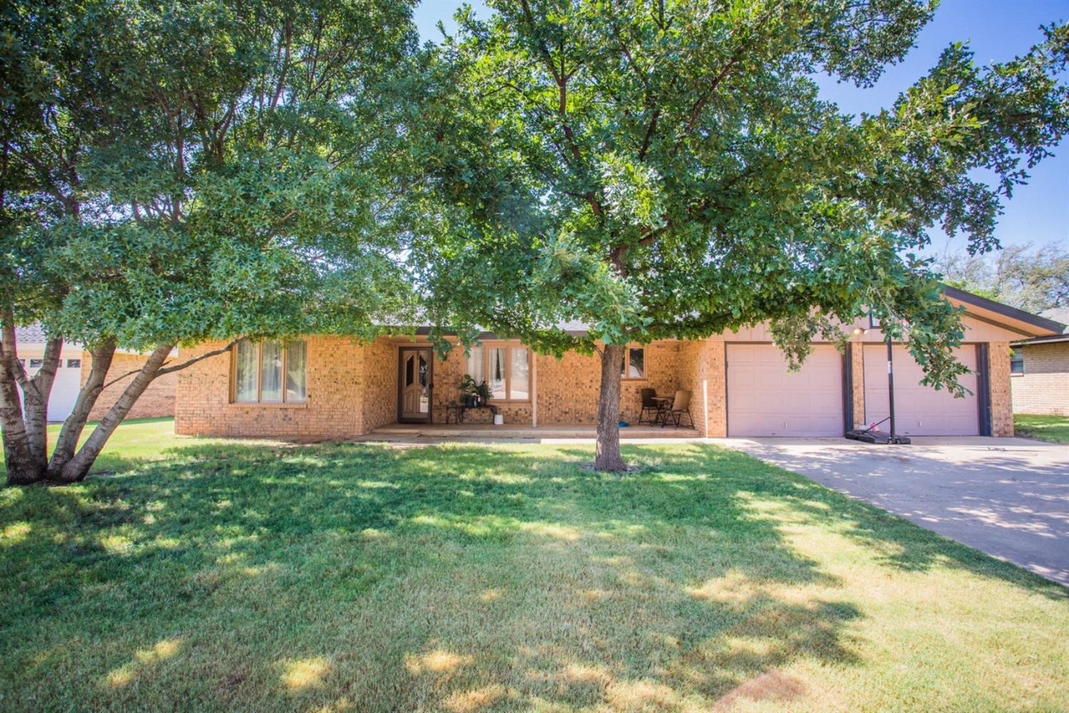 2118 Tech Drive Levelland, TX 79336 - Photo 3 of 42 a white house that has a tree in front of it