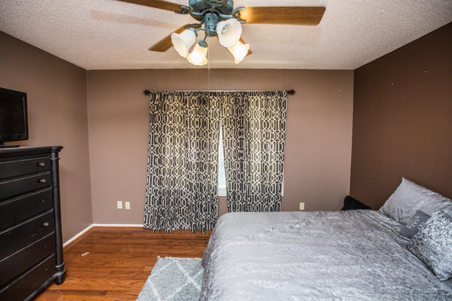 2118 Tech Drive Levelland, TX 79336 - Photo 33 of 42 a bedroom with a bed and a chandelier