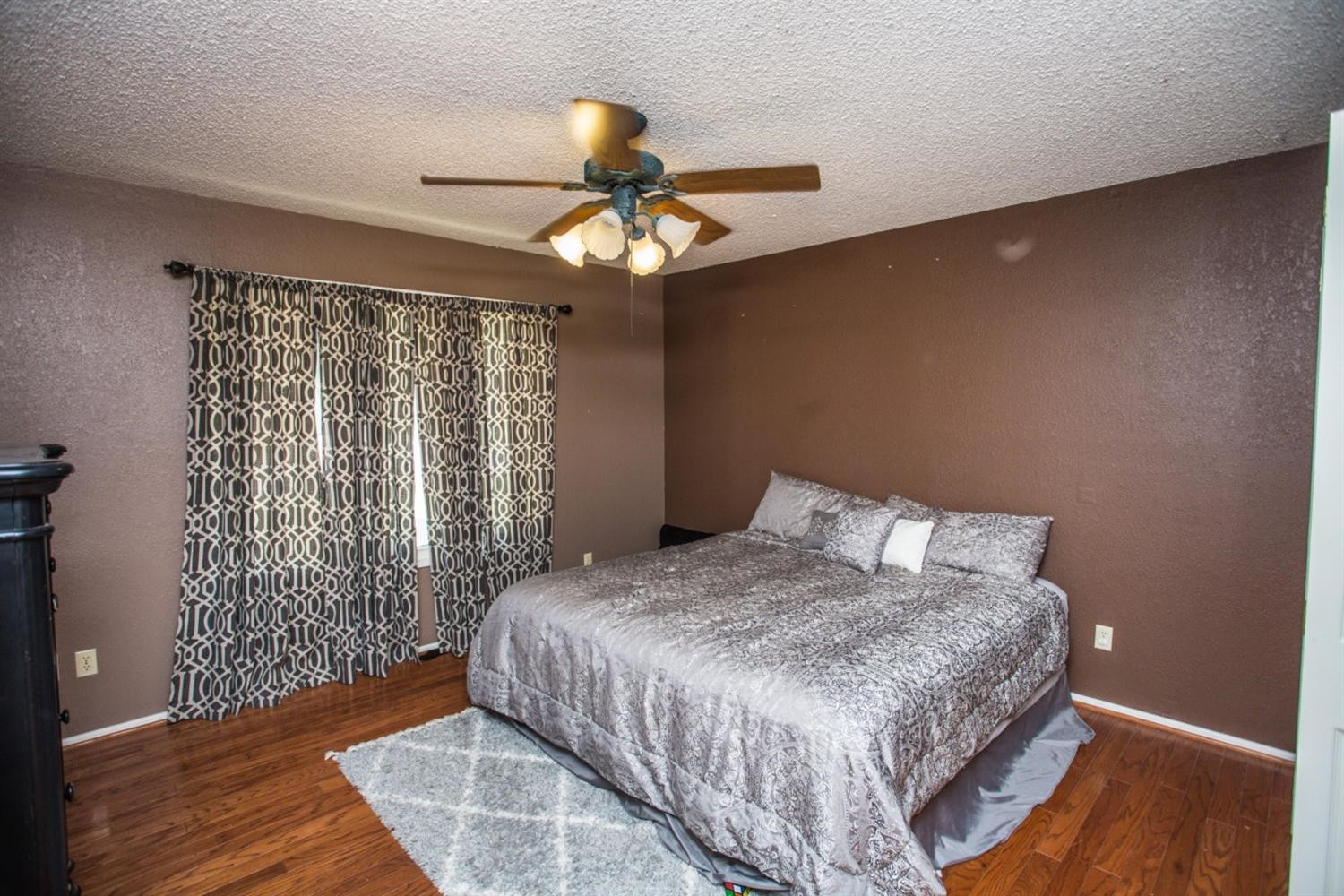 2118 Tech Drive Levelland, TX 79336 - Photo 35 of 42 a bedroom with a bed and a chandelier