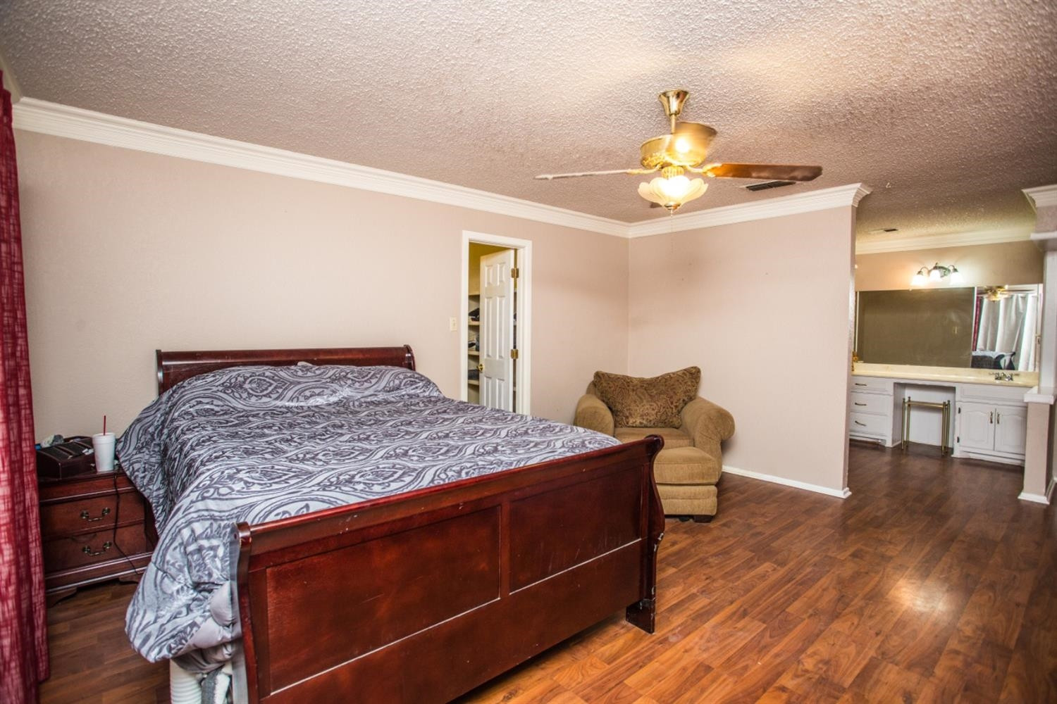 2118 Tech Drive Levelland, TX 79336 - Photo 38 of 42 a bedroom with a bed and wooden floor