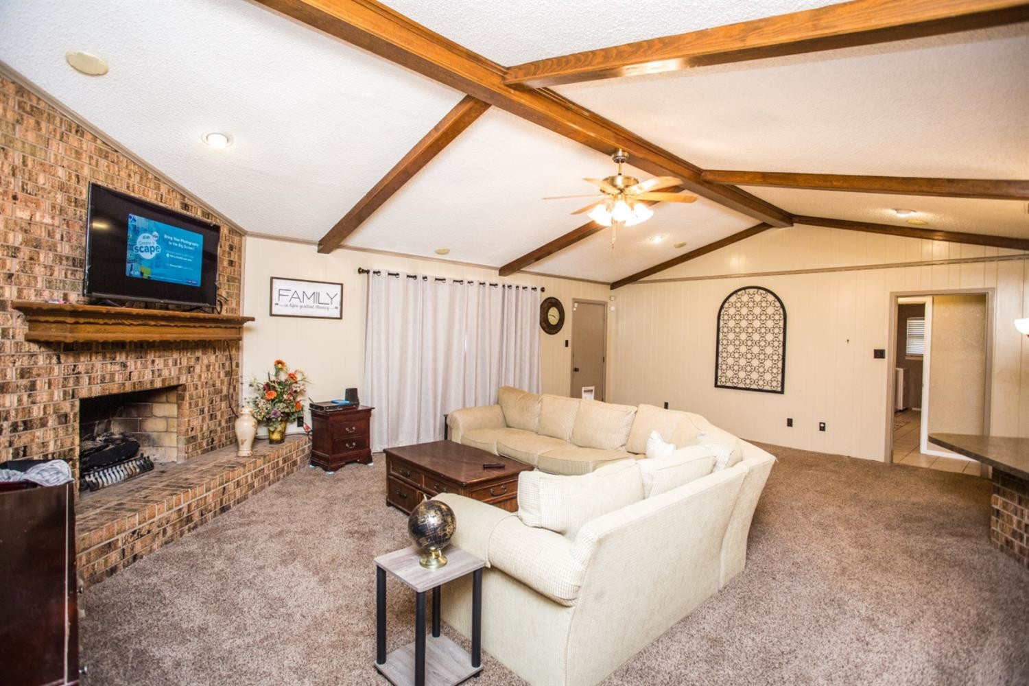 2118 Tech Drive Levelland, TX 79336 - Photo 7 of 42 a living room with furniture a fireplace and a flat screen tv