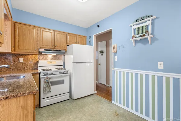 a bathroom with a granite countertop sink and a window