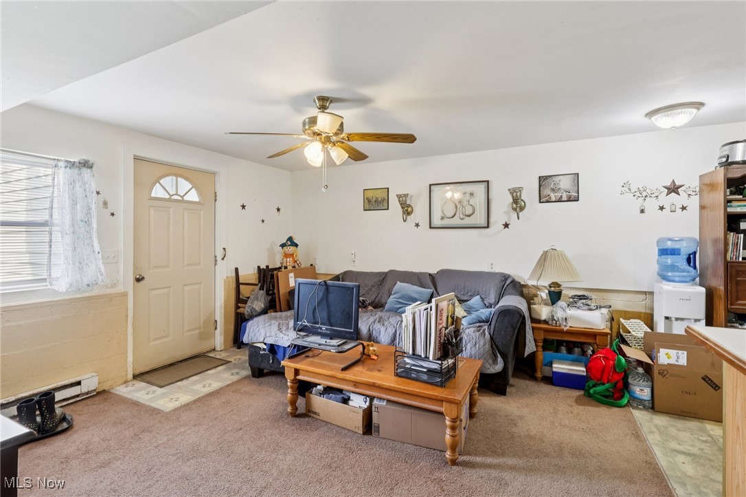 6370 Trumbull Road Geneva, OH 44041 - Photo 27 of 50 Living area with carpet, baseboard heating, and ceiling fan