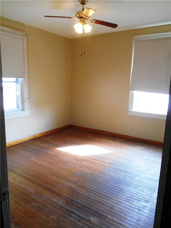 1165 Race Street McKees Rocks, PA 15136 - Photo 13 of 25 Additional room #1 has hardwood floors and a ceiling fan. This could also be another bedroom if a closet is added.