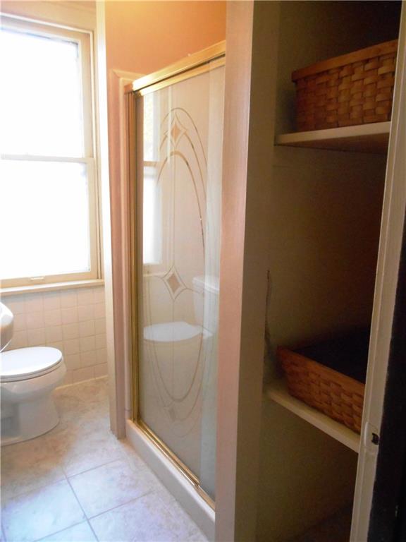 1165 Race Street McKees Rocks, PA 15136 - Photo 15 of 25 The bathroom has been updated more recently. Shelves have been added for storage.