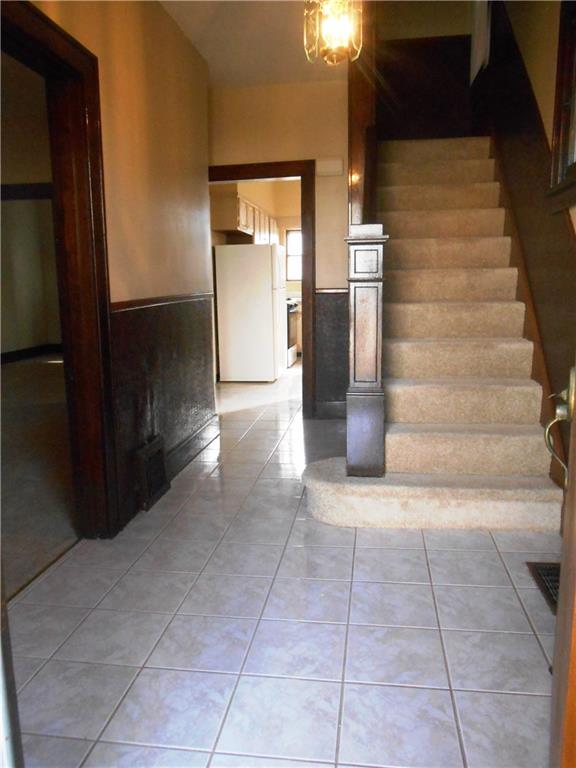 Large entry with tile floors that opens into the living room to the left.  ALL original woodwork throughout!! 