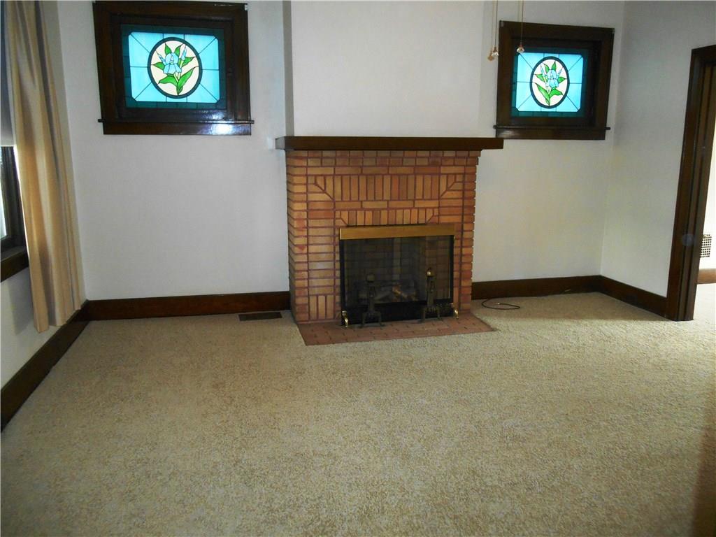 Brick fireplace and two stained glass windows help to bring the charm and character to this beautiful home!