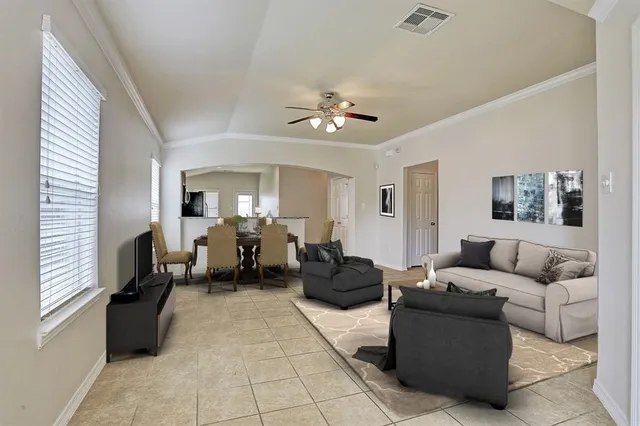 a living room with furniture and a chandelier