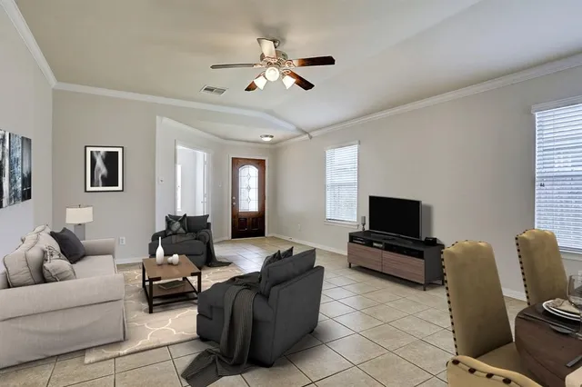a living room with furniture and a flat screen tv