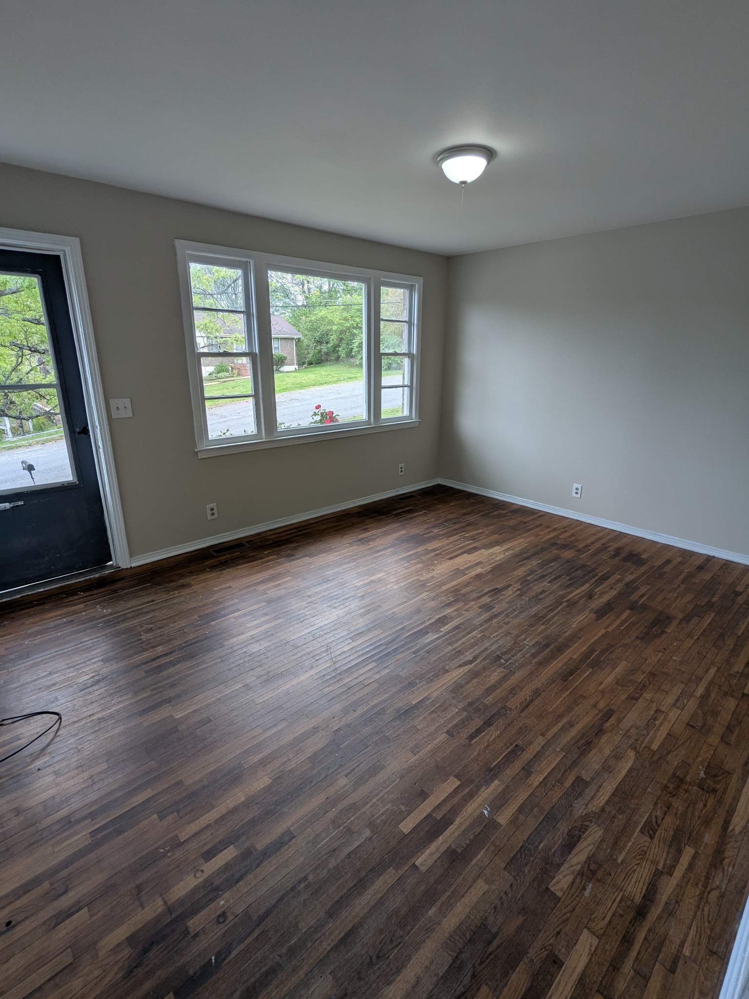 4721 McBride Road Antioch, TN 37013 - Photo 5 of 12 an empty room with wooden floor and windows