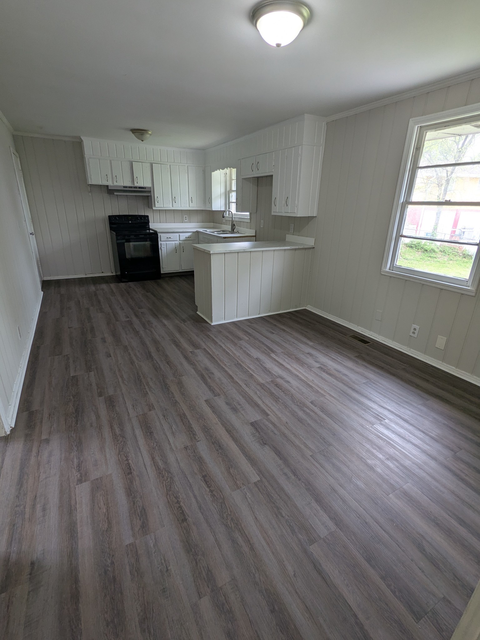 4721 McBride Road Antioch, TN 37013 - Photo 6 of 12 a kitchen with cabinets wooden floor and a window