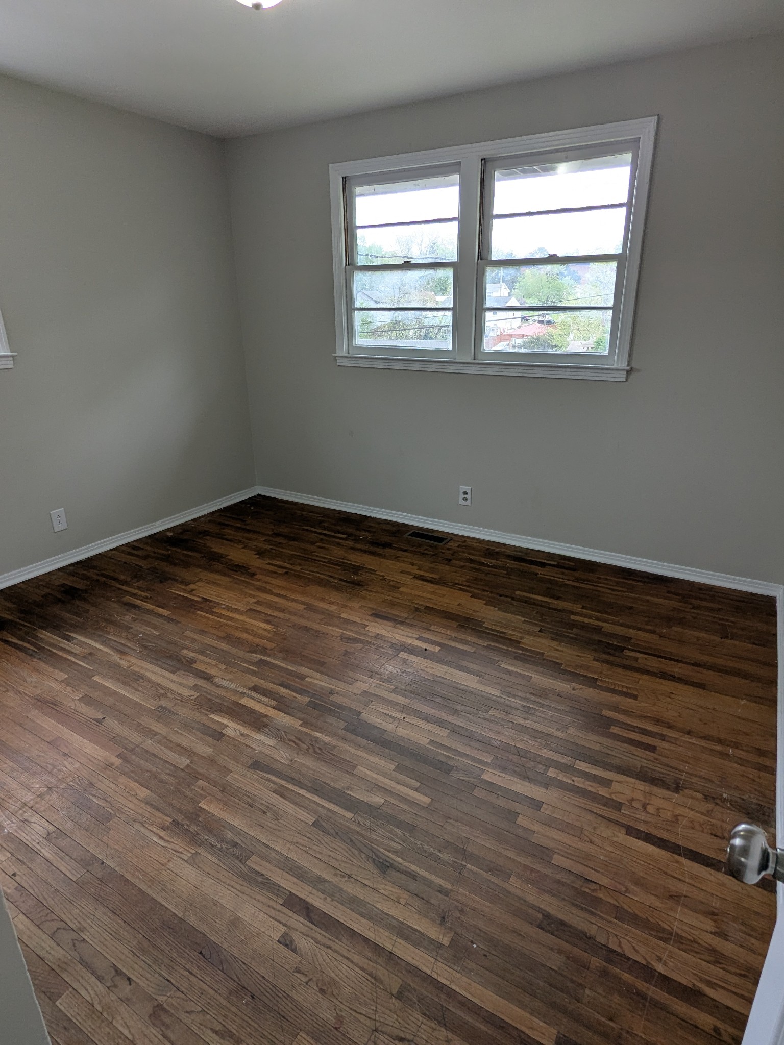 4721 McBride Road Antioch, TN 37013 - Photo 9 of 12 a view of an empty room with wooden floor and a window