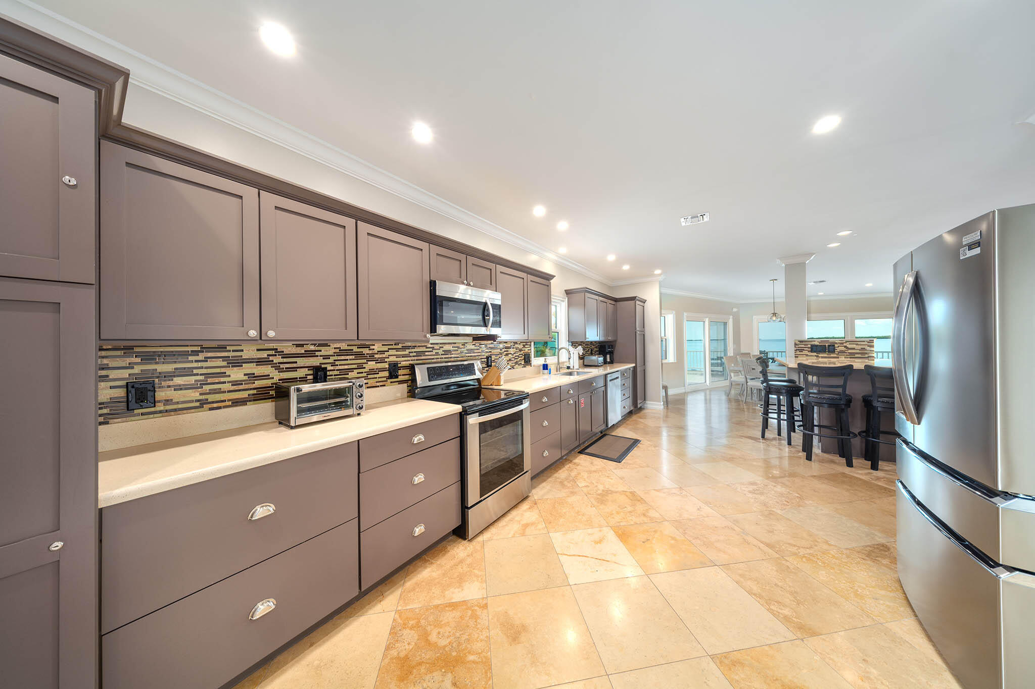 31473 Warner Street Big Pine Key, FL 33043 - Photo 11 of 49 a kitchen with counter top space cabinets and stainless steel appliances
