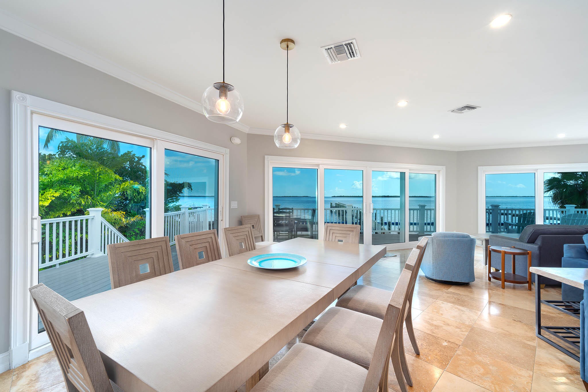 31473 Warner Street Big Pine Key, FL 33043 - Photo 15 of 49 a dining room with furniture a chandelier and wooden floor