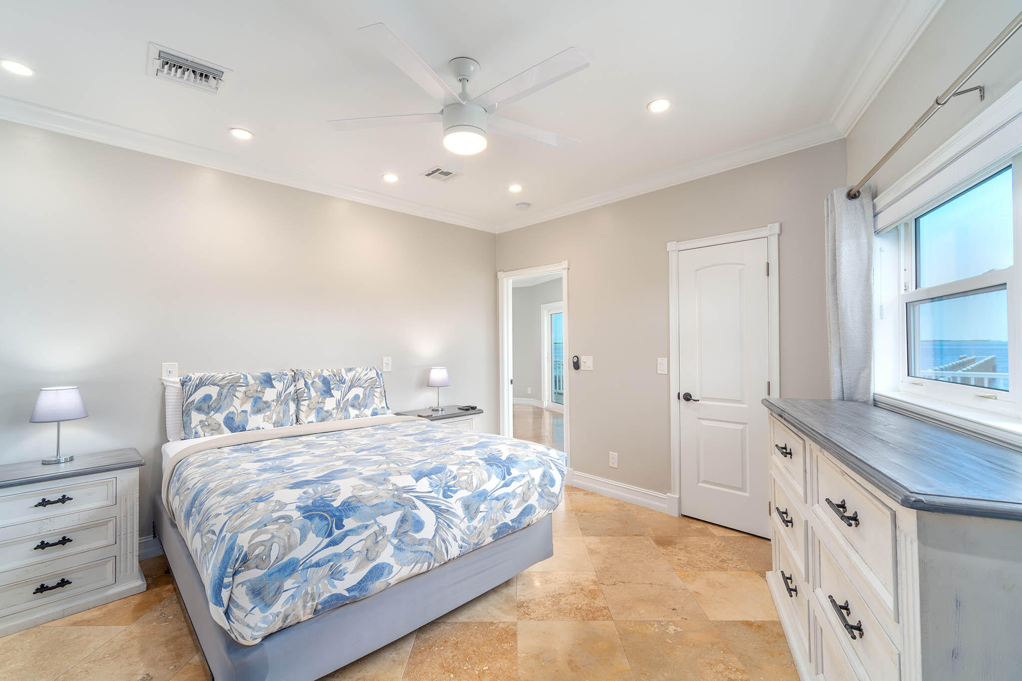 31473 Warner Street Big Pine Key, FL 33043 - Photo 22 of 49 a bedroom with a large bed and a chandelier