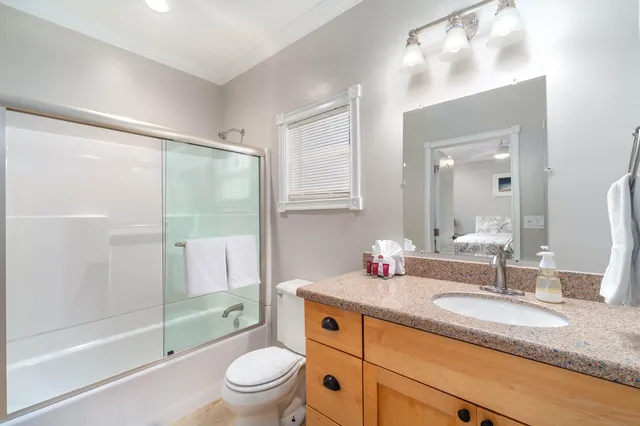 a spacious bedroom with a bed and a flat screen tv