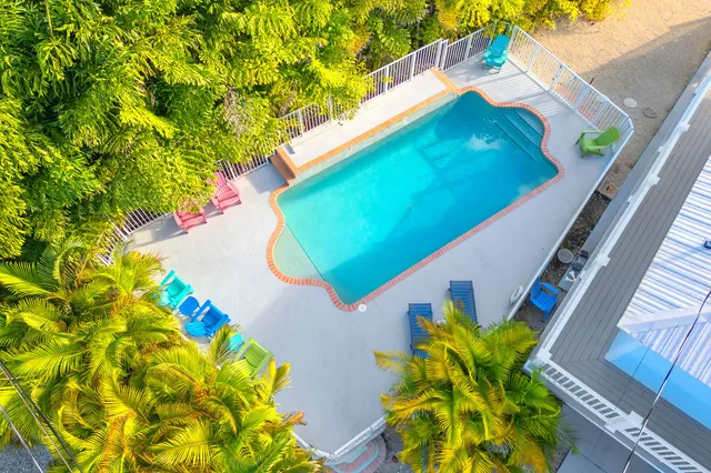 a view of balcony with wooden floor and seating
