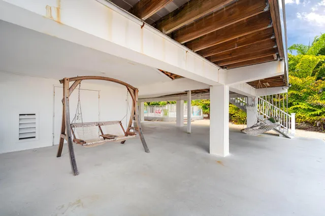 a view of a patio with a table and chairs in front of it