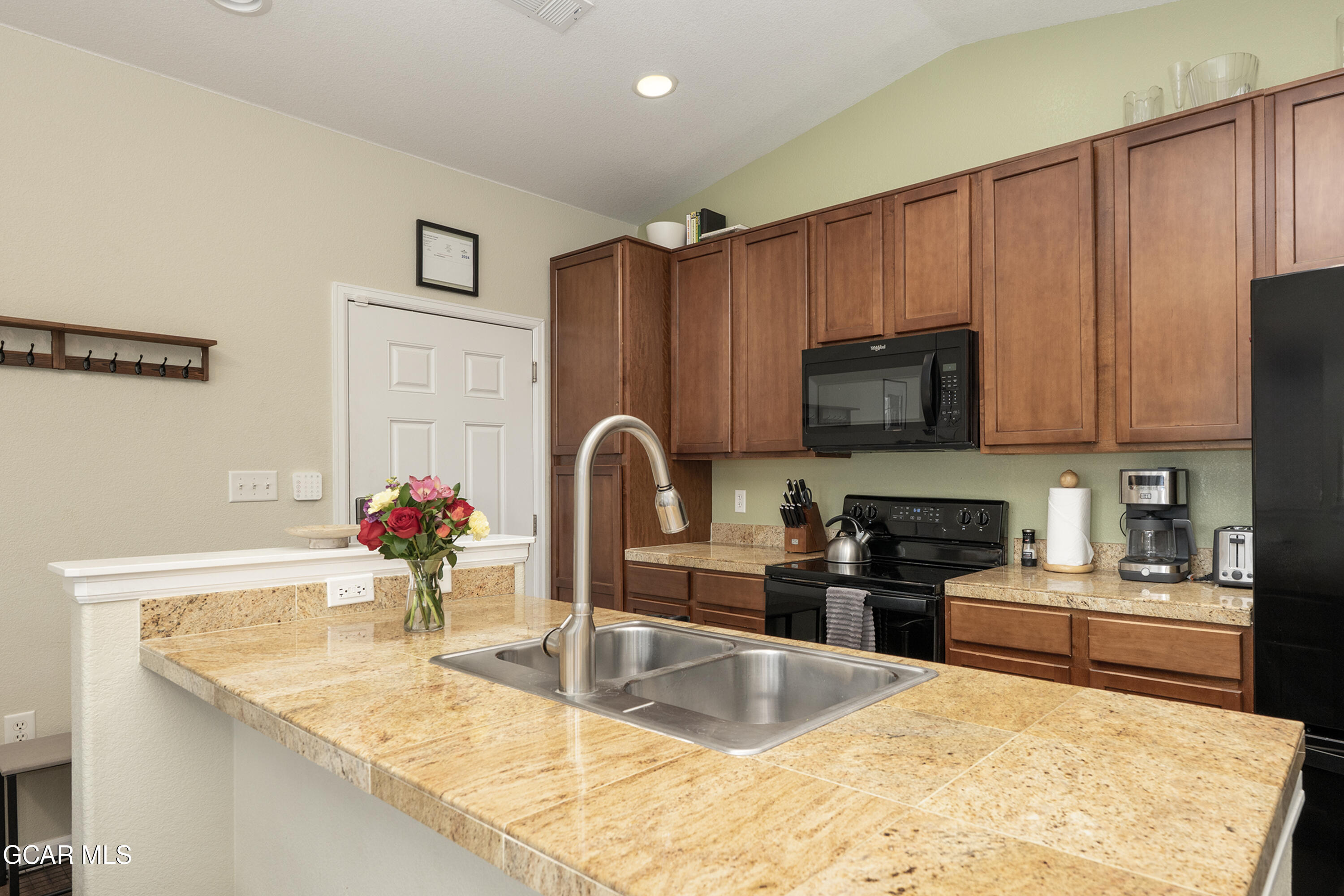 150 Village Road, Unit A307 Granby, CO 80446 - Photo 4 of 34 a kitchen with granite countertop a sink stainless steel appliances and cabinets