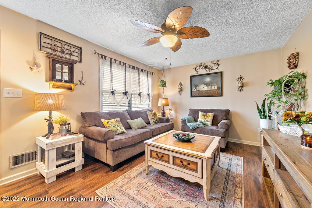 112 Bowsprit Road Manahawkin, NJ 08050 - Photo 5 of 47 a living room with furniture and a chandelier