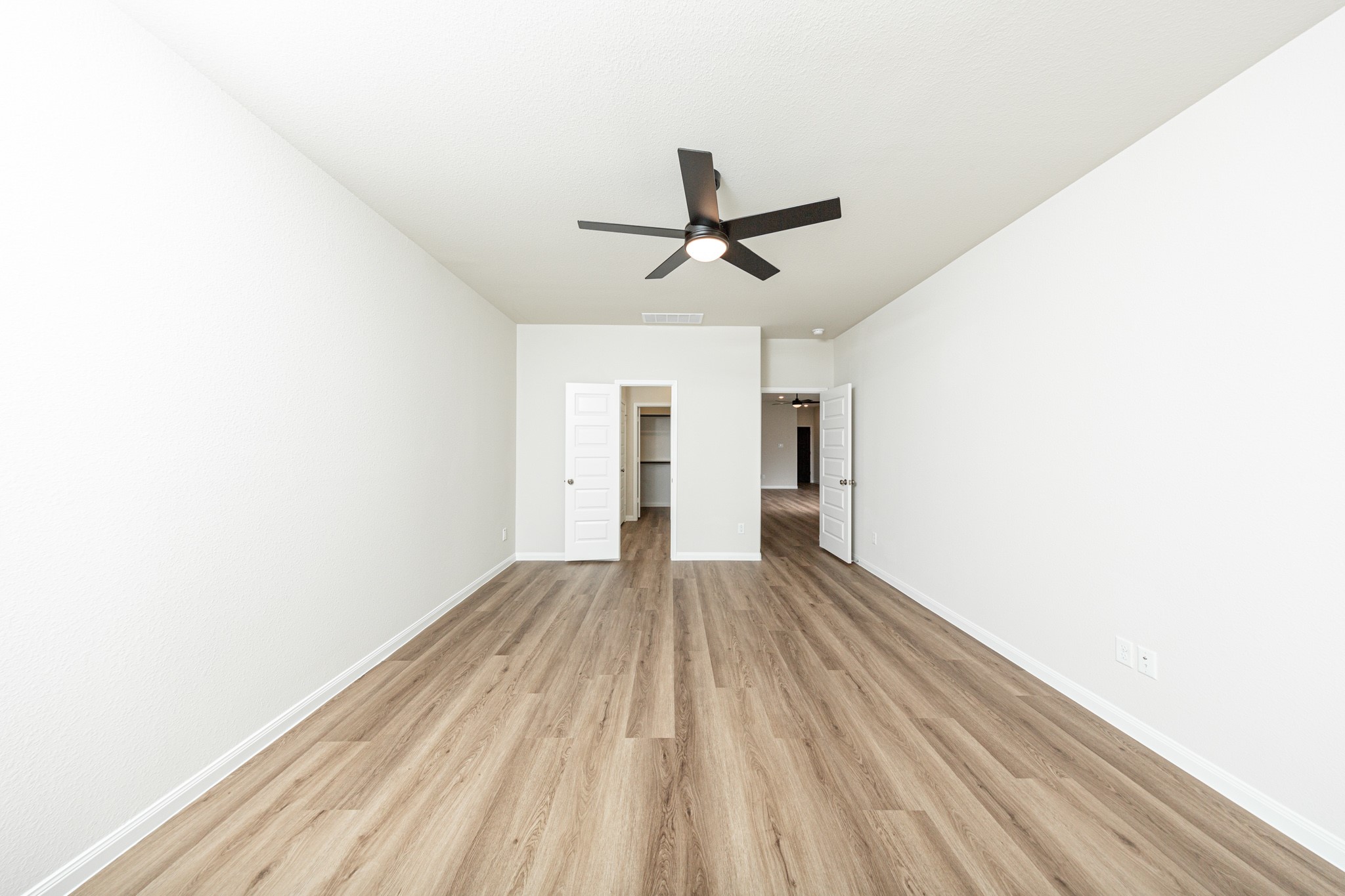 13651 Kit Run Splendora, TX 77372 - Photo 8 of 27 a view of empty room with wooden floor and ceiling fan