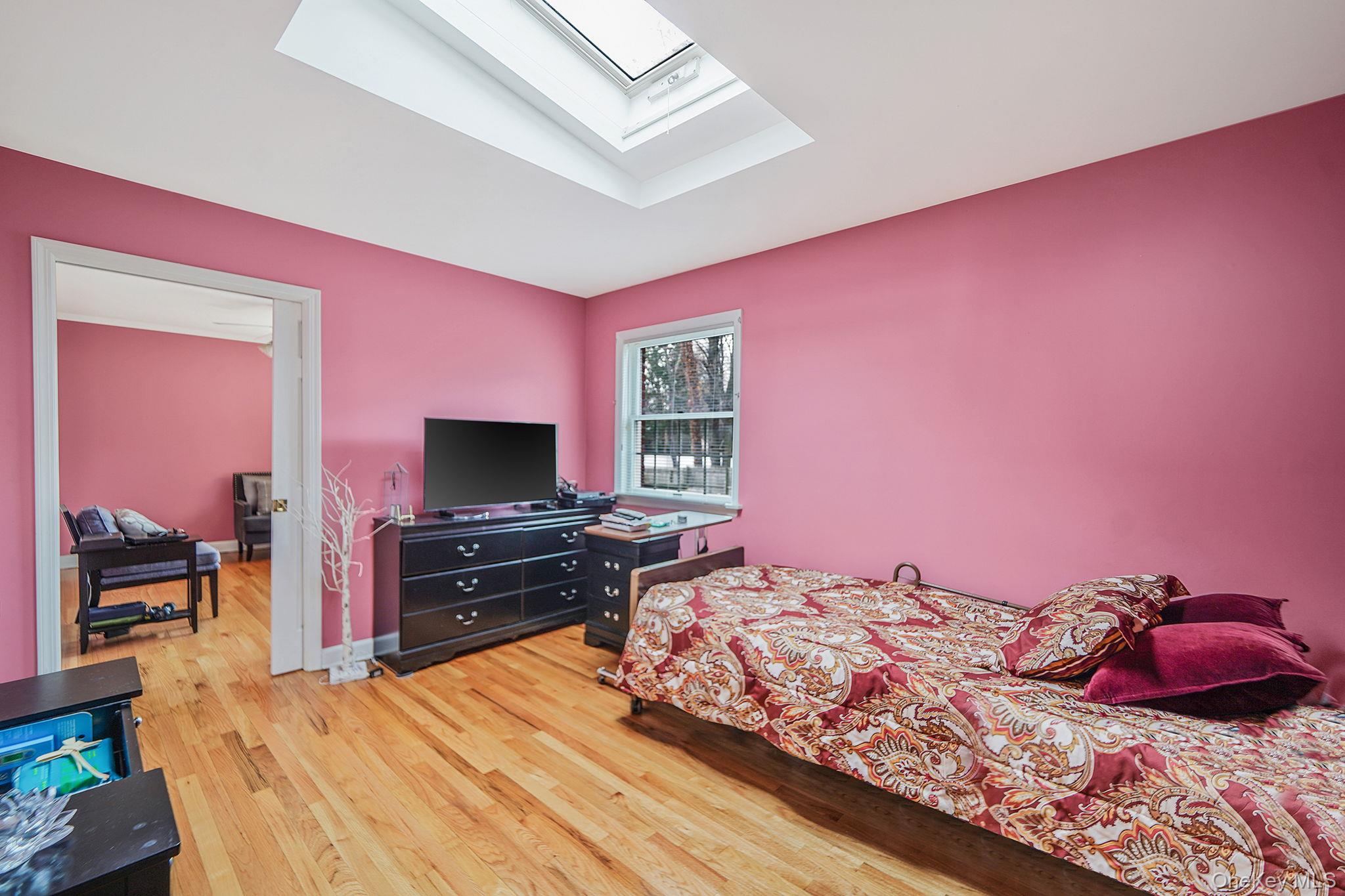 7 Rugby Road Westbury, NY 11590 - Photo 19 of 46 Bedroom with a skylight and light wood finished floors