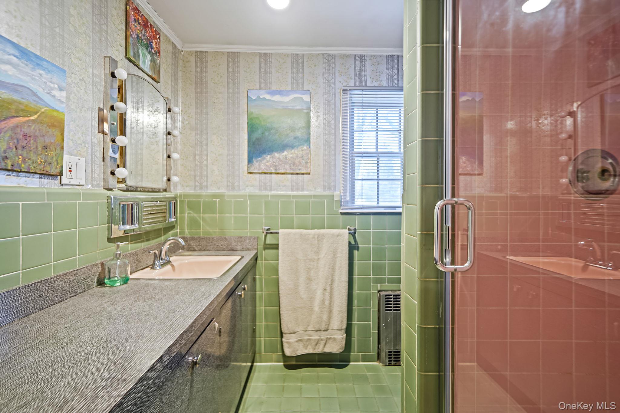 7 Rugby Road Westbury, NY 11590 - Photo 27 of 46 Bathroom featuring wallpapered walls, crown molding, vanity, tile walls, and a tile shower