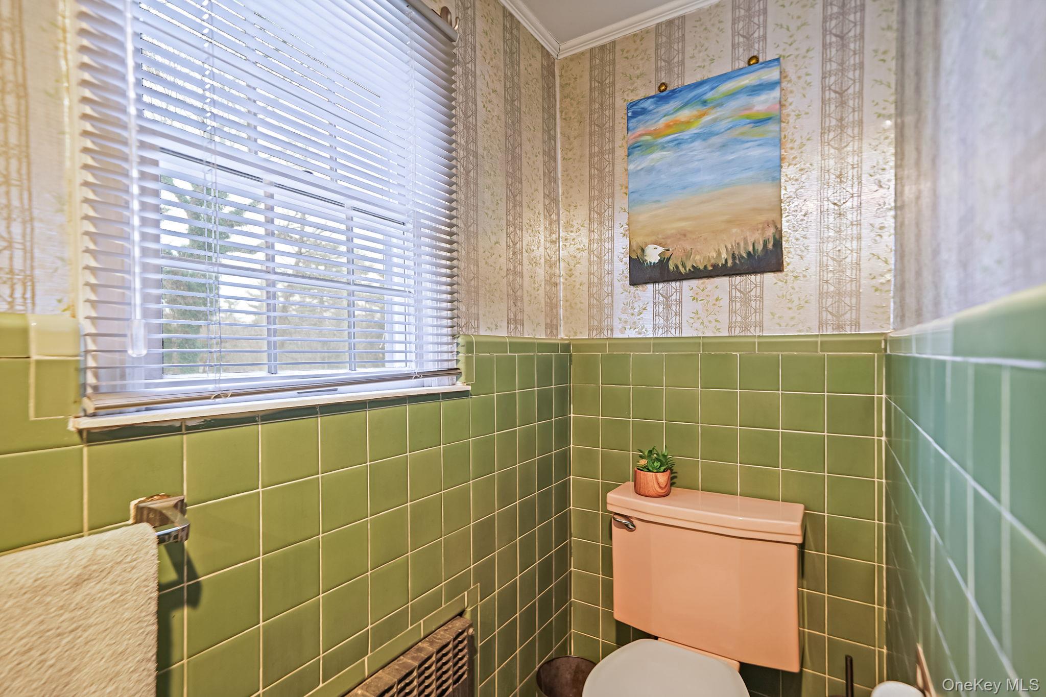 7 Rugby Road Westbury, NY 11590 - Photo 28 of 46 Bathroom featuring wallpapered walls, wainscoting, ornamental molding, and tile walls